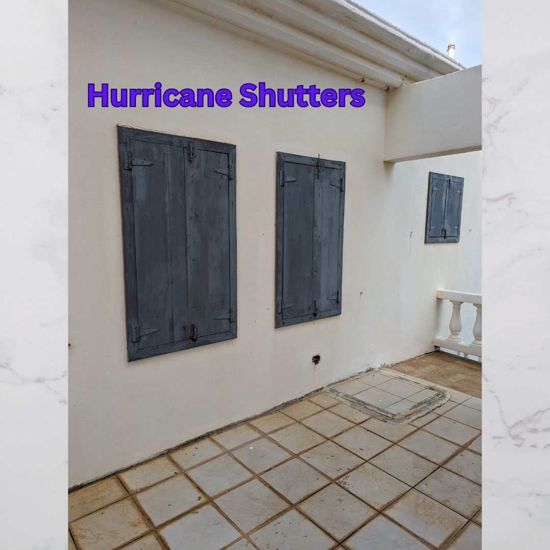 Cottage with closed hurricane shutters