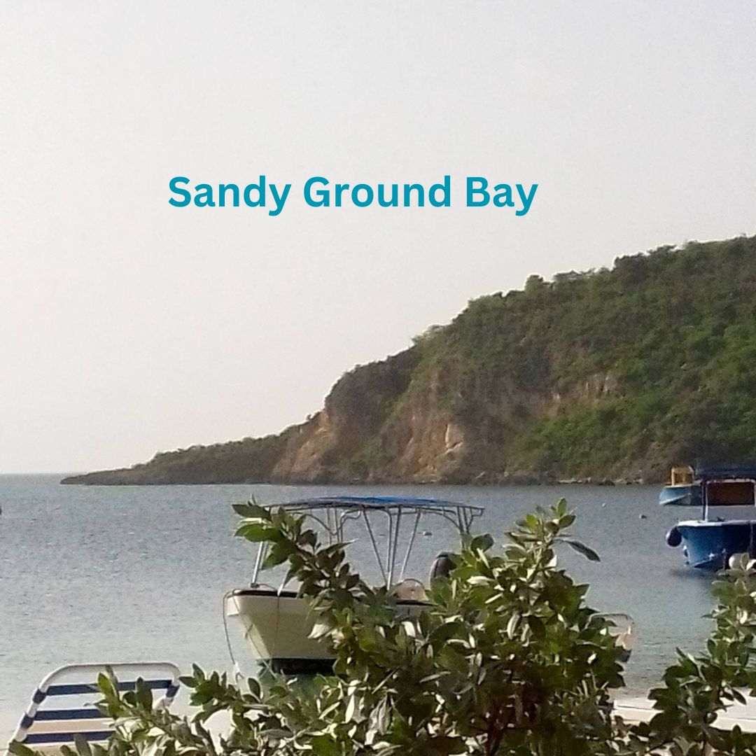 View of sea from the beach with a ridge sloping to the sea to the right.